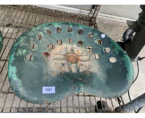 A VINTAGE CAST METAL IMPLEMENT SEAT