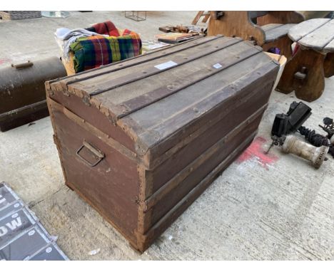 A VINTAGE COMPRESSED FIBRE TRUNK WITH WOODEN BANDING