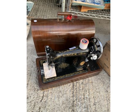 A VINTAGE SINGER SEWING MACHINE WITH WOODEN CARRY CASE