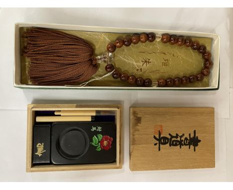 TWO ORIENTAL ITEMS, BEADS AND A CALLIGRAPHY SET