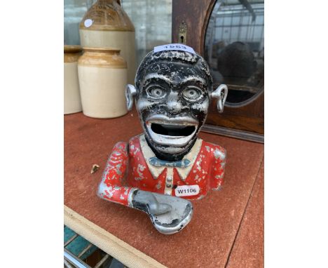 A VINTAGE CAST METAL JOLLY MAN MONEY BOX Notice from the the-saleroom.com: These items are listed on the basis they are illus