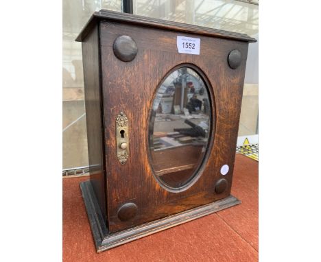 A VINTAGE OAK SMOKERS CABINET WITH BEVELED GLASS FRONT