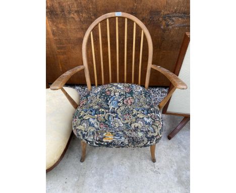 AN ERCOL BLUE LABEL ARM CHAIR WITH SPINDLE BACK