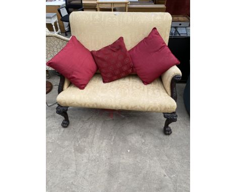 A MAHOGANY CHIPPENDALE STYLE TWO SEATER SOFA WITH LION MASK DECORATION ON CABRIOLE LEGS WITH CLAW FEET