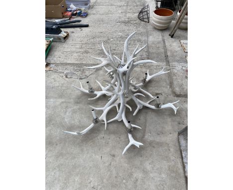 A LARGE DECORATIVE CEILING LIGHT FITTING FORMED FROM ANTLERS