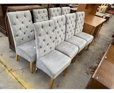 A SET OF EIGHT HIGH BUTTON BACK FULLY UPHOLSTERED DINING CHAIRS