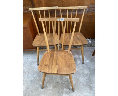 A SET OF THREE ERCOL BLUE LABEL ELM AND BEECH STICK BACK CHAIRS