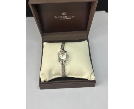 A LADIES BULOVA 10 CARAT WHITE GOLD PLATED WRIST WATCH IN A PRESENTATION BOX SEEN WORKING BUT NO WARRANTY