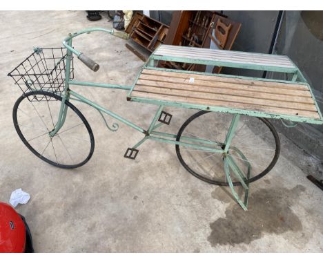 A VINTAGE STYLKE METAL SHOP DISPLAY BIKE WITH FOLDING BENCH SIDES AND A STORAGE SECTION