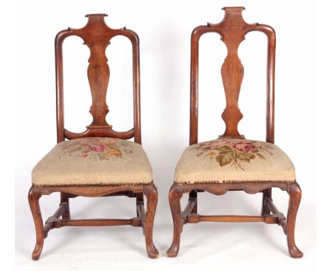 A NEAR PAIR OF EARLY 18TH CENTURY WALNUT DUTCH STYLE SIDE CHAIRS with scroll carved top rails, vase shaped back splats, tapes