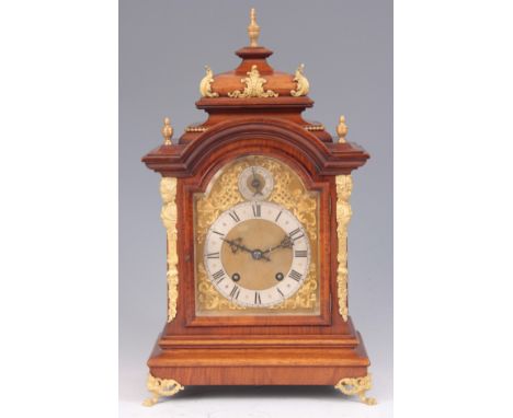 A LATE 19TH CENTURY GERMAN WALNUT AND ORMOLU MOUNTED BRACKET CLOCK the caddy top above an arched glazed door flanked by ormol