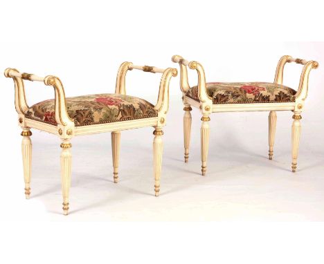 A PAIR OF 20TH CENTURY REGENCY STYLE GILT DECORATED PAINTED WINDOW SEATS  having out swept arms and leaf work decoration, uph