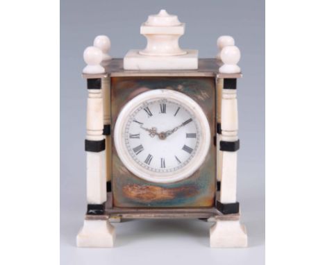 AN EARLY 20TH CENTURY FRENCH IVORY AND EBONY MOUNTED BOUDOIR CLOCK the silver-plated case surmounted by a turned ivory pedime