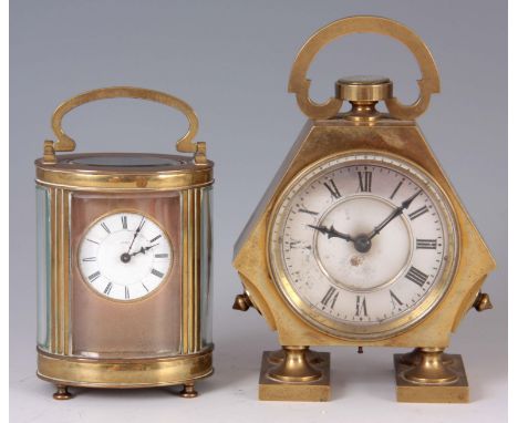 AN EDWARDIAN BRASS DESK CLOCK WITH COMPASS FITTED TO THE TOP of angular form with a hinged door, silvered dial with Roman num