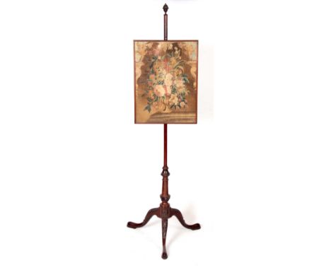 A GEORGE III MAHOGANY SCREEN with glazed rectangular panel enclosing a floral 18TH Century tapestry; the tripod base with lea