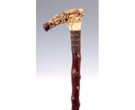 AN UNUSUAL 19TH CENTURY CARVED IVORY HANDLED WALKING CANE on blackthorn stick with woven collar 98.5cm high