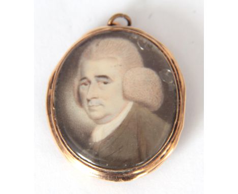 A GEORGE III MINIATURE PORTRAIT ON IVORY in a glazed oval gold metal frame 40mm high 