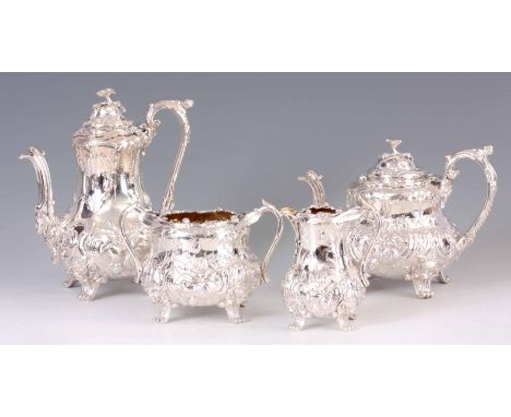 A FINE QUALITY VICTORIAN SILVER FOUR PIECE TEA SERVICE retailed by Lambert &amp; Rawlings,  profusely chased with floral and 