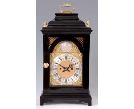 AN EBONISED DOUBLE FUSEE BRACKET CLOCK the case with inverted bell top surmounted by a hinged brass handle above a glazed doo