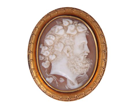 A 19th CENTURY CAMEO BROOCH depicting a portrait of Bacchus on gold colored frame 46mm high 38mm wide 