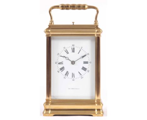 A LATE 19TH CENTURY FRENCH BRASS GORGE CASE REPEATING CARRIAGE CLOCK with bevelled glazed panelled case and white enamel dial
