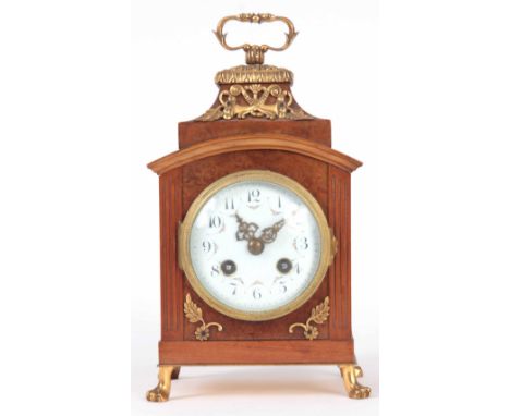 A LATE 19TH CENTURY FRENCH AMBOYNA AND ORMOLU MOUNTED MANTEL CLOCK the case standing on claw feet and surmounted by a hinged 