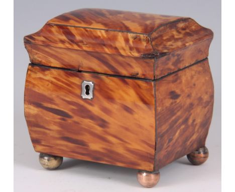 A 19TH CENTURY OGEE SHAPED BLOND TORTOISESHELL TEA CADDY with a divided lidded interior, on small brass ball feet 11.5cm wide