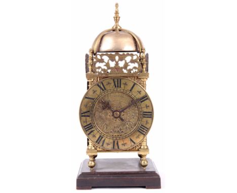 A SMALL FRENCH LANTERN STYLE MANTEL CLOCK the brass case surmounted by a steel bell above a 4" Roman dial with tulip engraved