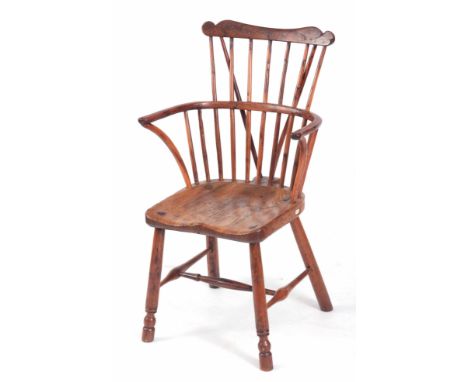 AN EARLY 19TH CENTURY BURR YEW-WOOD COMB BACK WINDSOR CHAIR with shaped top rail, spindle supports and crook arms; having dis