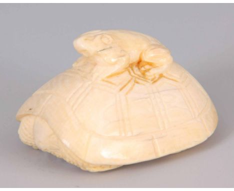 A LATE 19TH CENTURY JAPANESE IVORY NETSUKE formed as a frog mounted on a tortoise's back 4.5cm wide.
