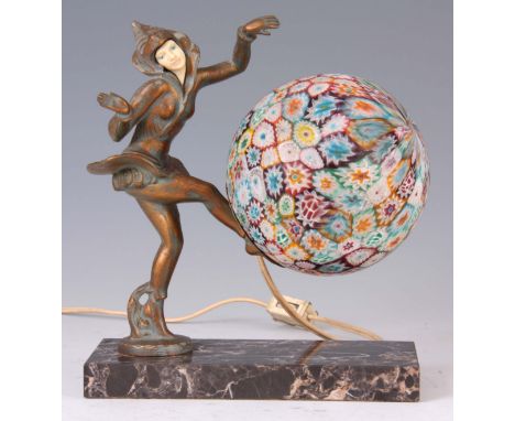AN ART DECO FIGURAL LAMP WITH A MILLEFIORI GLASS SHADE the spelter dancing girl with gilt finish standing on a veined marble 