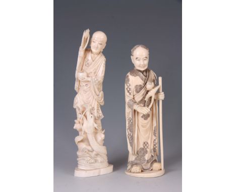 TWO MEIJI PERIOD JAPANESE IVORY FIGURES the larger with an entwined dragon, the smaller of an older gentleman with a walking 