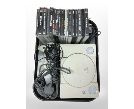 A Sony Playstation 1 with lead, controller, and a quantity of games.