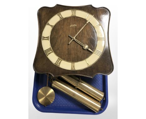 A Junghans wall clock with pendulum and weights.