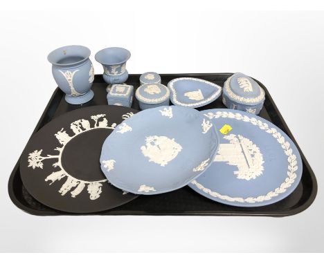 A group of Wedgwood blue and white Jasperware trinket boxes, dishes, similar plate on black ground, etc.