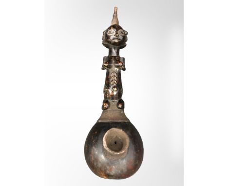 A Luba carved wooden gourd pipe with copper binding, length 47cm.