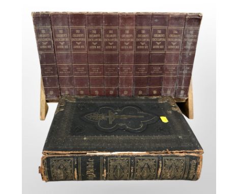 A Victorian tooled leather family Bible, together with an oak book trough containing volumes I-X The Children's Encyclopaedia
