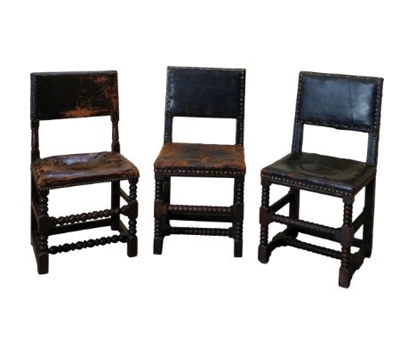A SET OF THREE CROMWELLIAN STYLE UPRIGHT CHAIRS with leather and brass close nail upholstered seats and backs, with bobbin-tu