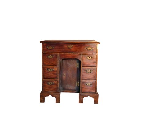A GEORGE III SMALL MAHOGANY KNEEHOLE DESK, the rectangular top with a moulded border above an arrangement of one long and six