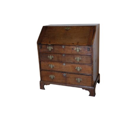 A WILLIAM AND MARY STYLE OAK BUREAU, the fall front opening to a fitted interior, above a dummy drawer and three long graduat