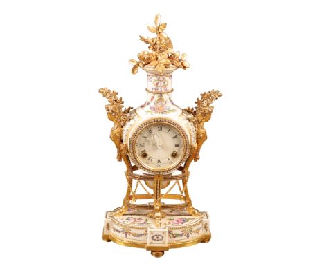 A MARIE ANTOINETTE MANTEL CLOCK, the porcelain case with gilt metal female caryatid mounts surmounted by a floral pediment, t