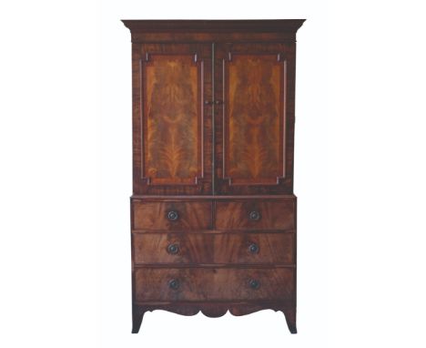 A GEORGE III MAHOGANY LINEN PRESS, the upper part with projecting dentil cornice over two panelled doors enclosing trays, the