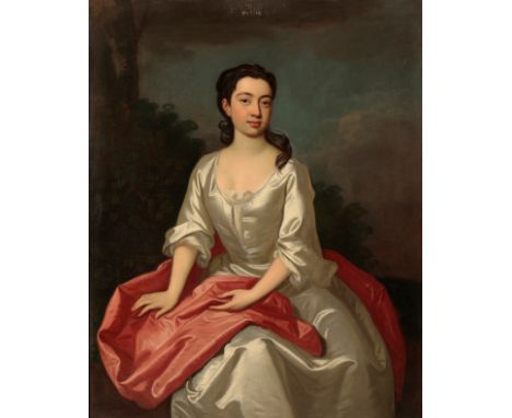 SIR GODFREY KNELLER (1646-1723) A portrait of a young lady wearing an oyster silk gown with a red sash, depictedÂ&nbsp; seate