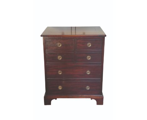 A GEORGE III MAHOGANY BEDSIDE TABLE incorporating a commode, with a hinged lid and two simulated drawers enclosing the fitted