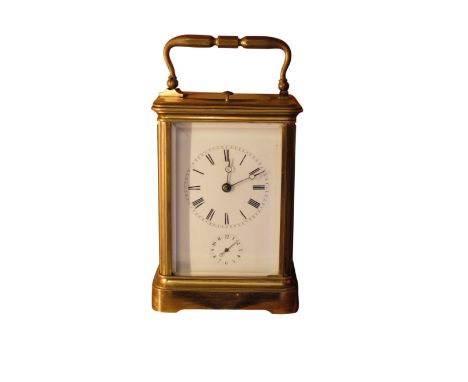 A FRENCH CARRIAGE CLOCK, the gilt brass case with carrying handle and bevel glazed panels, the white enamel dial with Roman n