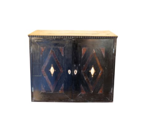 A BAROQUE TORTOISESHELL AND EBONISED COLLECTORS CABINET inlaid with geometric pewter stringing, with a pair of hinged doors i