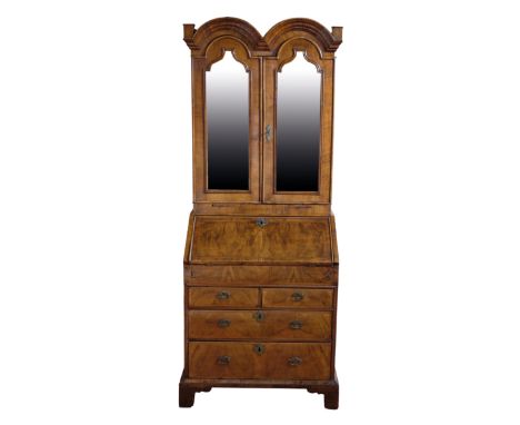 A QUEEN ANNE STYLE WALNUT DOUBLE DOME TOP BUREAU BOOKCASE of small proportions, the upper section with a pair of doors enclos