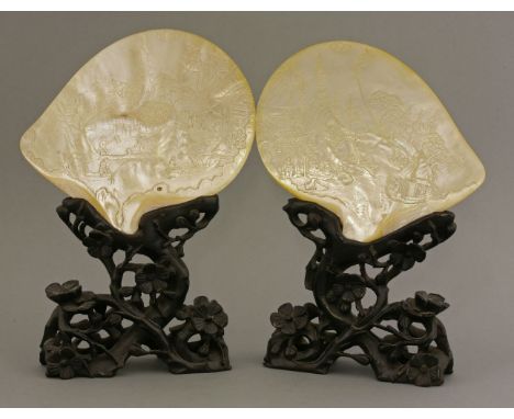 A pair of mother-of-pearl Shells,mid-19th century, each finely carved and engraved with figures in boats, working paddy field