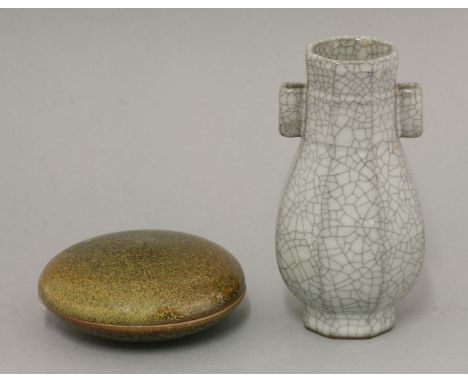 An attractive Arrow Vase,20th century, the faceted pear body with a wide ribbon at the neck and two square section handles, a