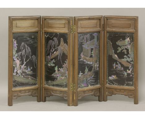 A rare four-fold black-lacquered Table Screen,the panels Kangxi (1662-1722), each black-lacquered ground minutely inlaid in a